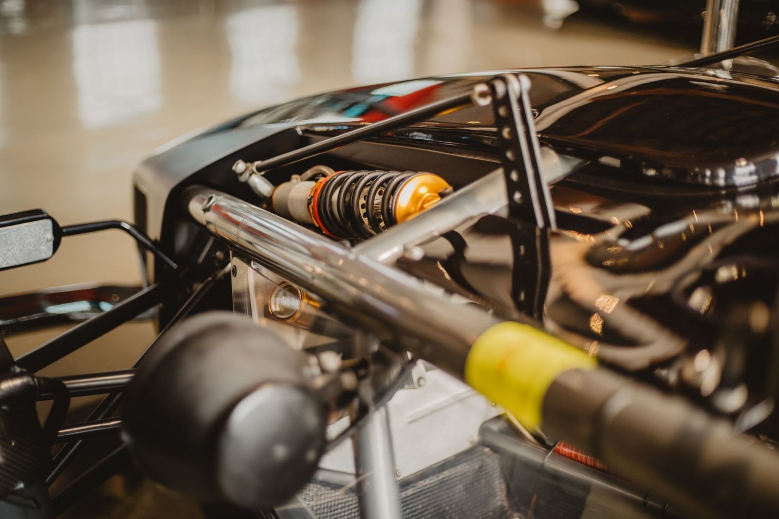 Detailed shot of a Formula One car suspension, showcasing automotive engineering.