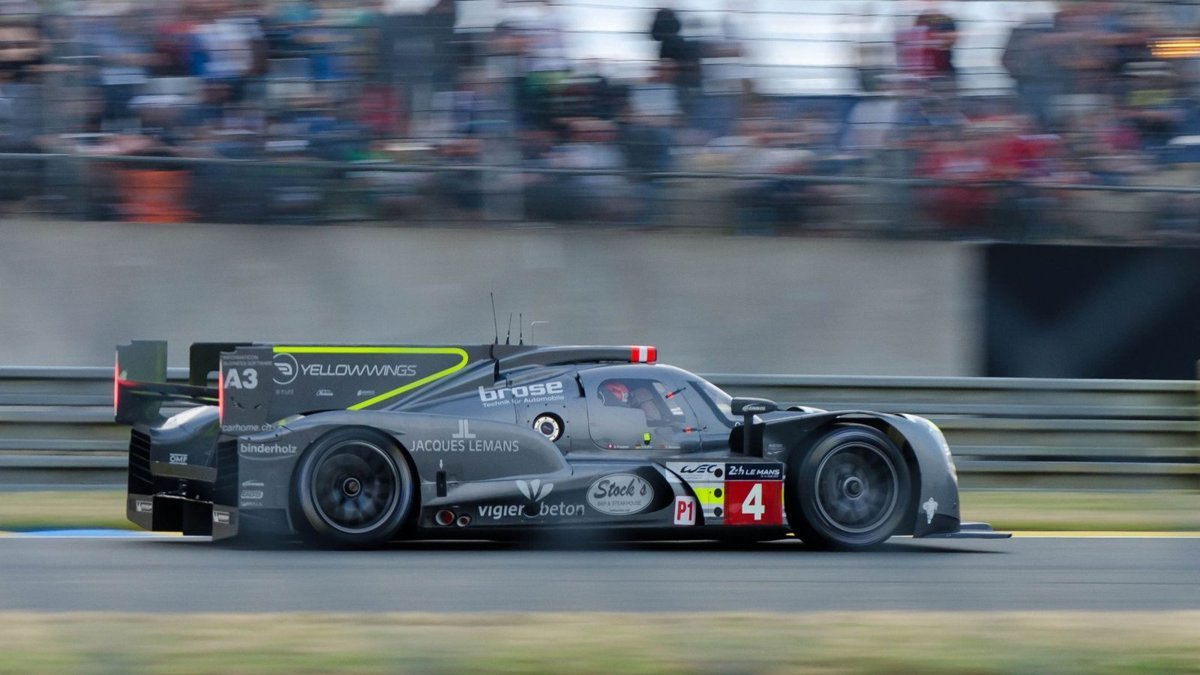 Dynamic shot of a racing car speeding on the Le Mans circuit, capturing the essence of endurance racing.
