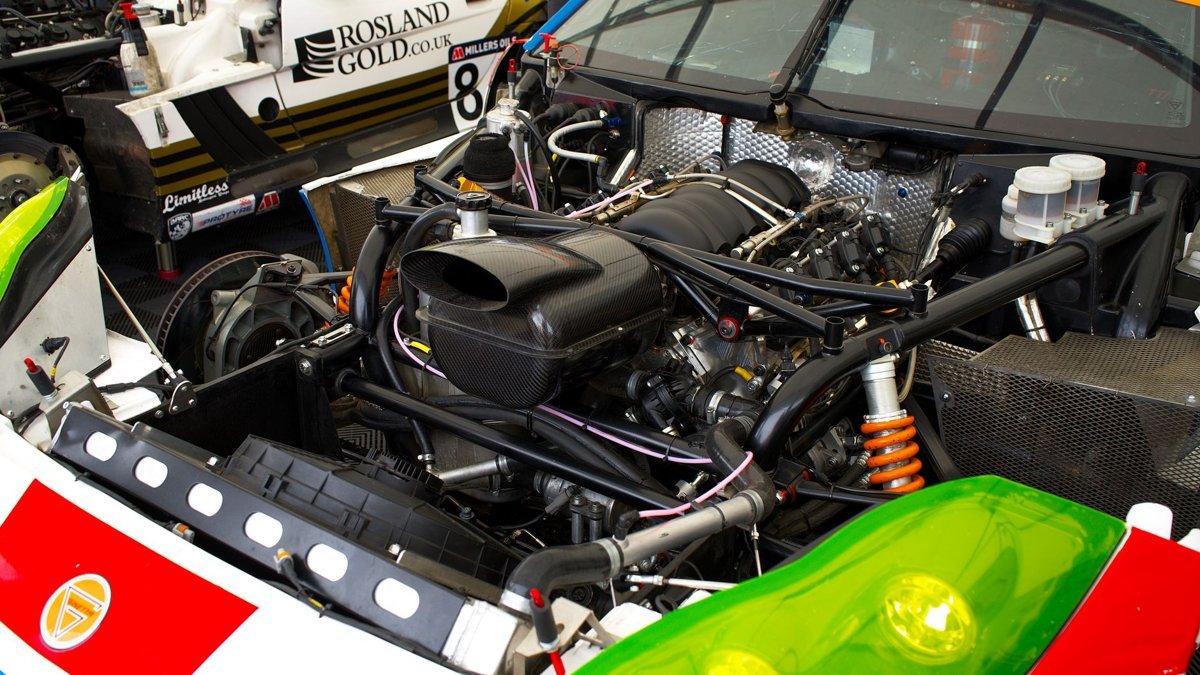 Detailed view of a high-performance race car engine at Silverstone, capturing the technical marvels of automotive engineering.